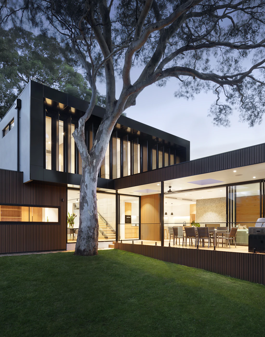 Ocean House No. 18 at dusk beneath mature trees